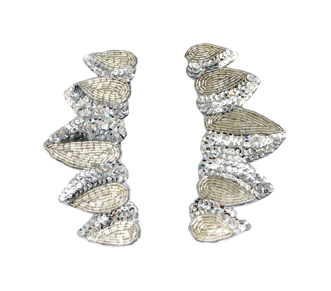 Pair of silver leaf-shaped patches on a black background