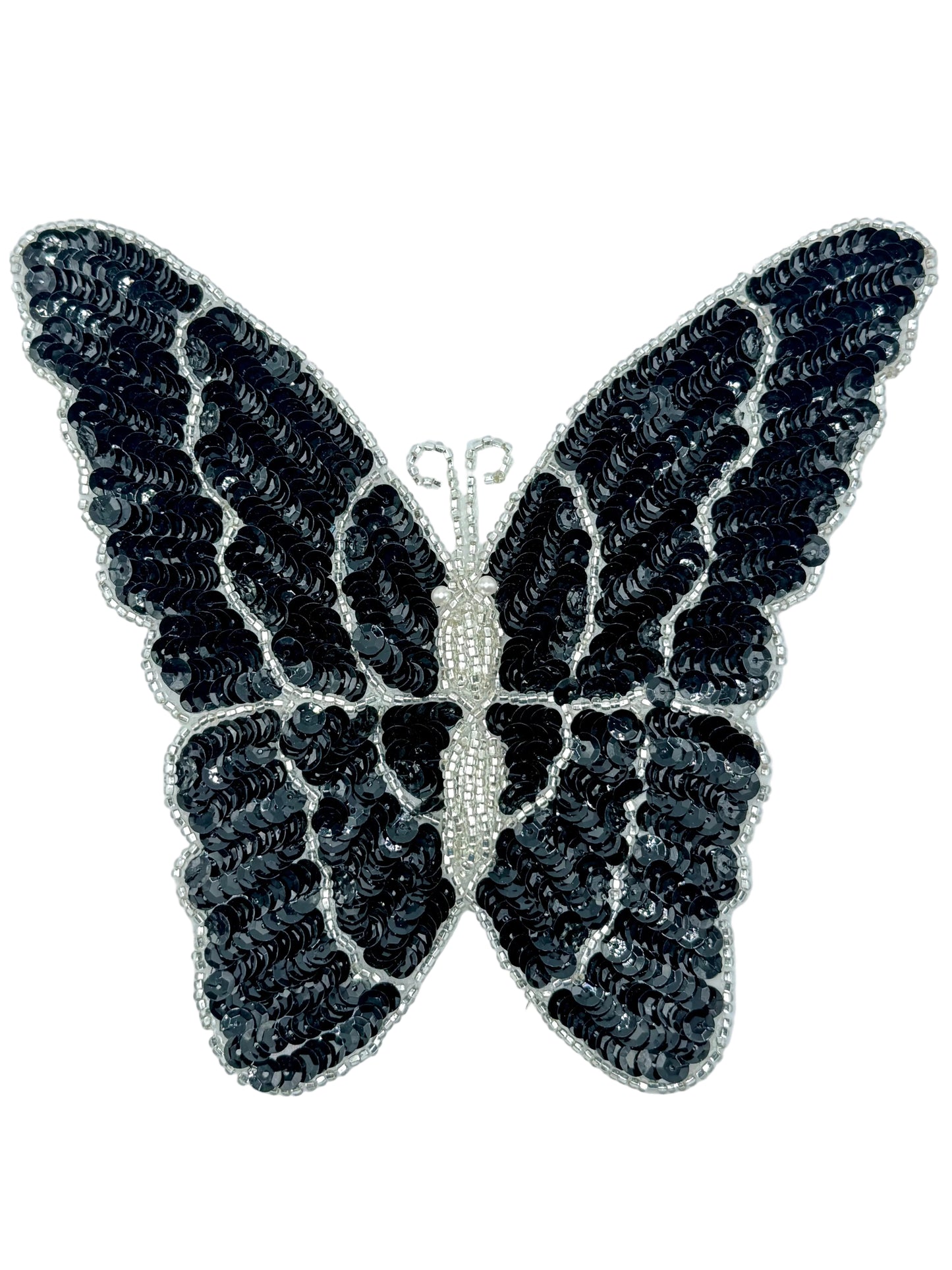Black butterfly-shaped decorative patch with sequins on a white background