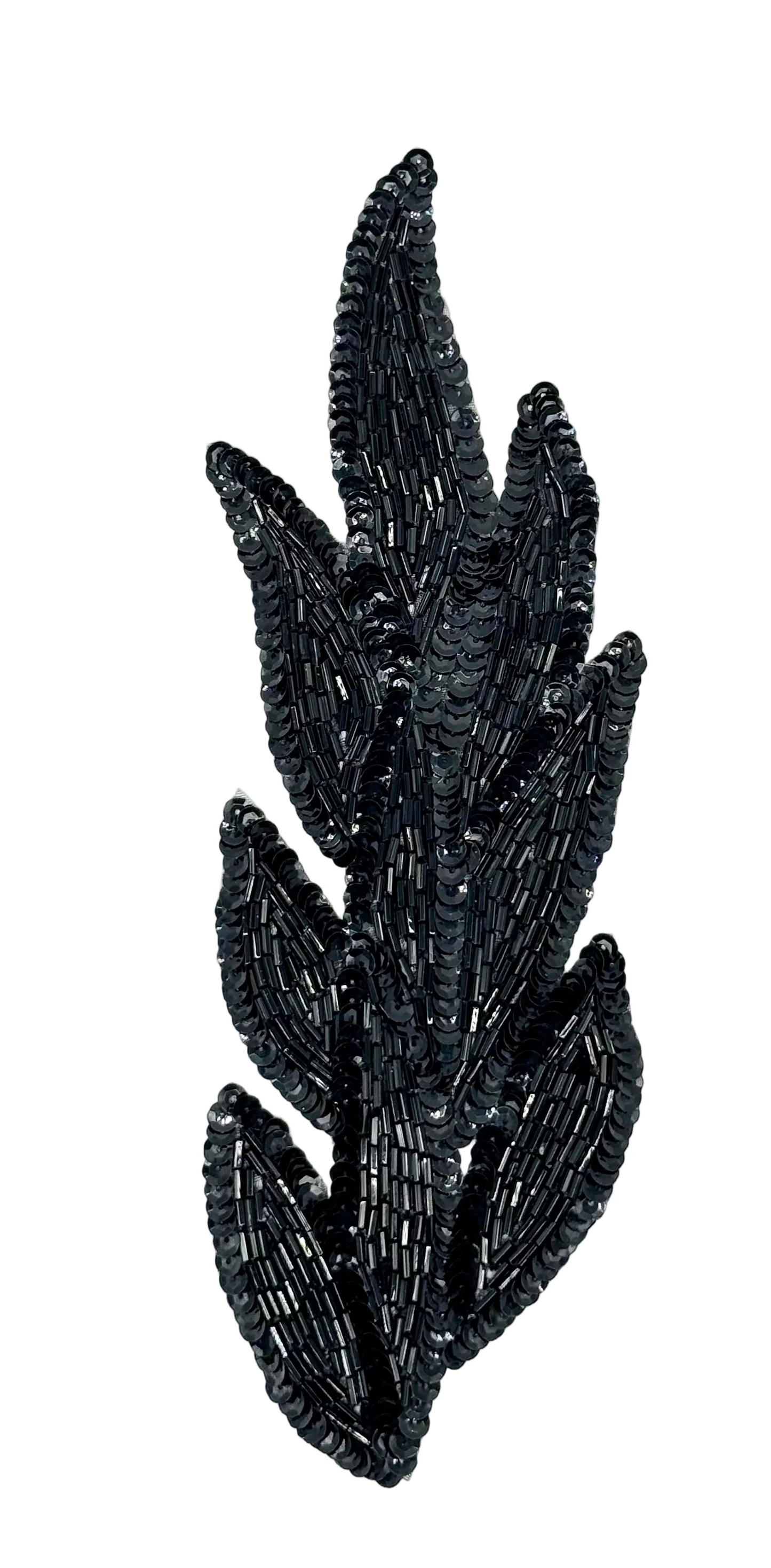 Black leaf-shaped sequin and bead decorative item on a white background