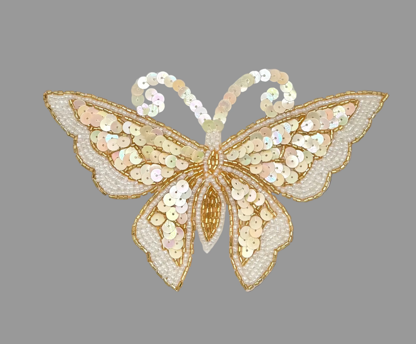 Decorative butterfly with sequins on a gray background