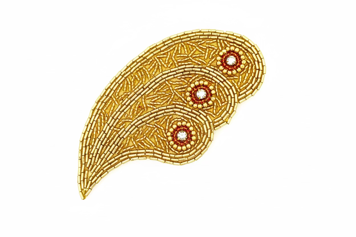 Decorative gold paisley design on a white background