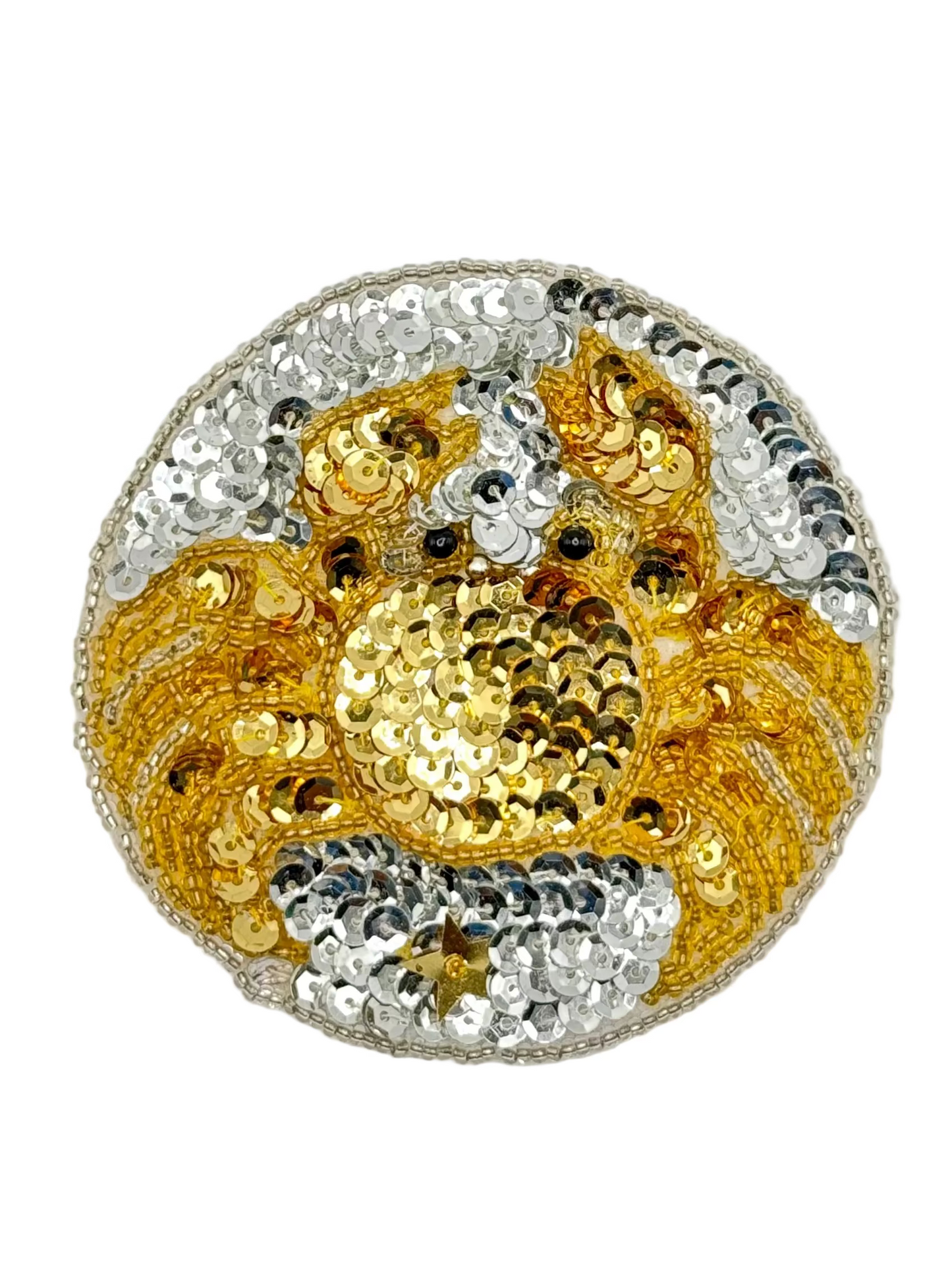 Decorative zodiac patch with gold and silver sequins on a white background