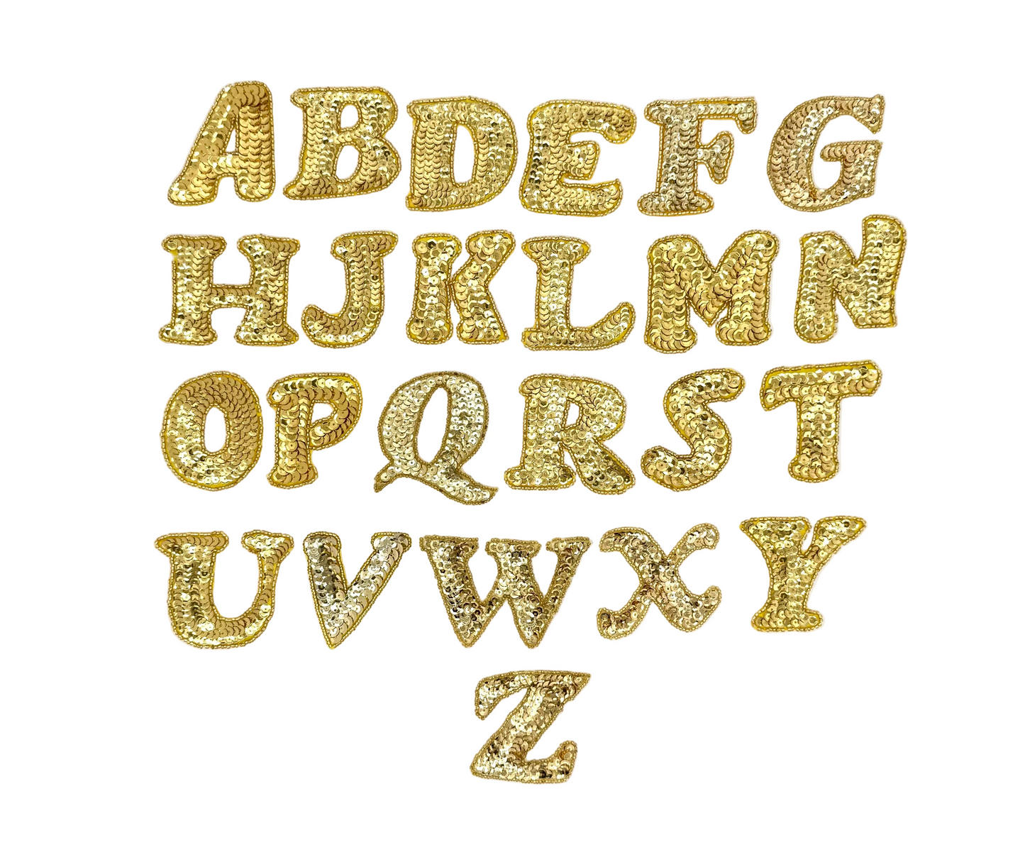Gold sequin and bead alphabet letters on a white background