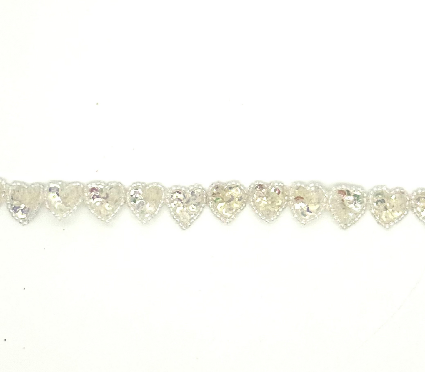 Heart-shaped sequin heart s by the yard on a white background