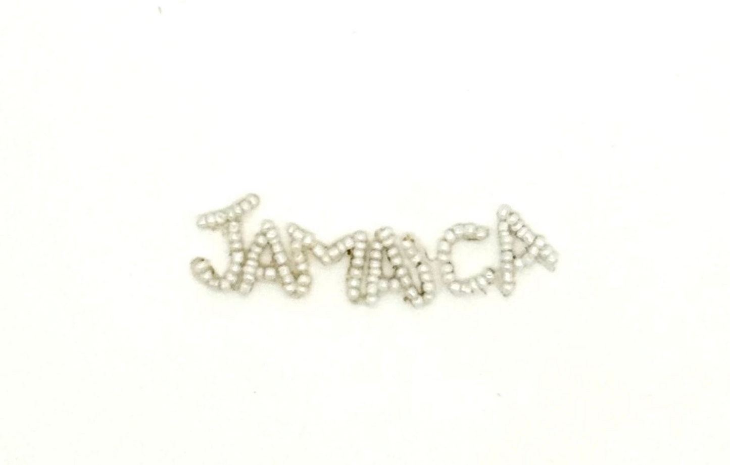The Word “Jamaica” White Glass Beads .5" x 3"