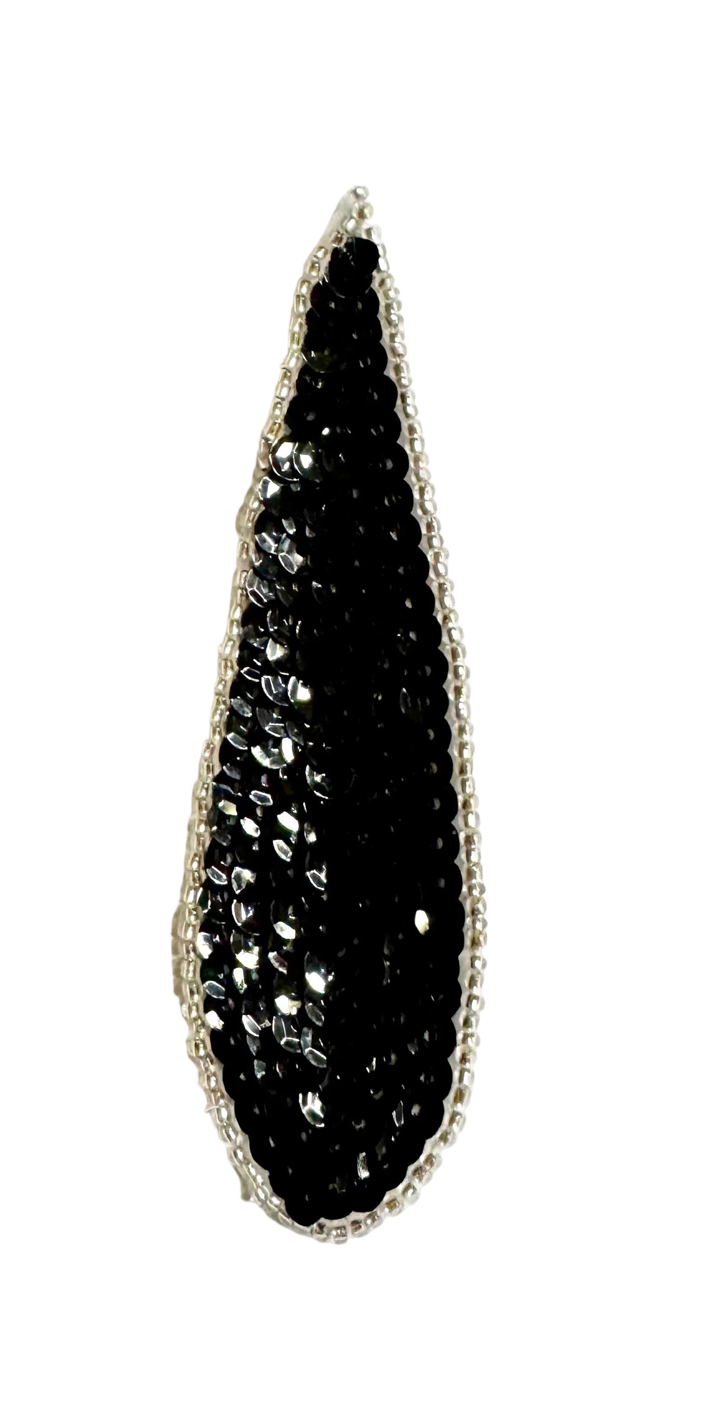 A teardrop-shaped black sequin patch with a silver-toned beaded border, displayed on a plain white background.