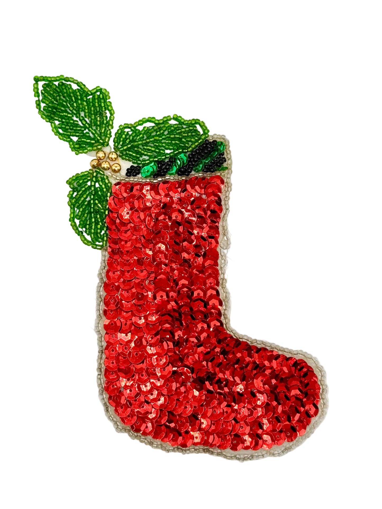A red sequined Christmas stocking embellishment with green beaded holly leaves and small gold bead accents, shown on a plain light background.