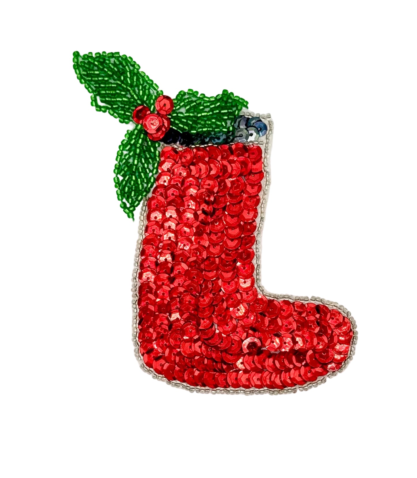 Red sequin Christmas stocking with green holly leaves on a white background