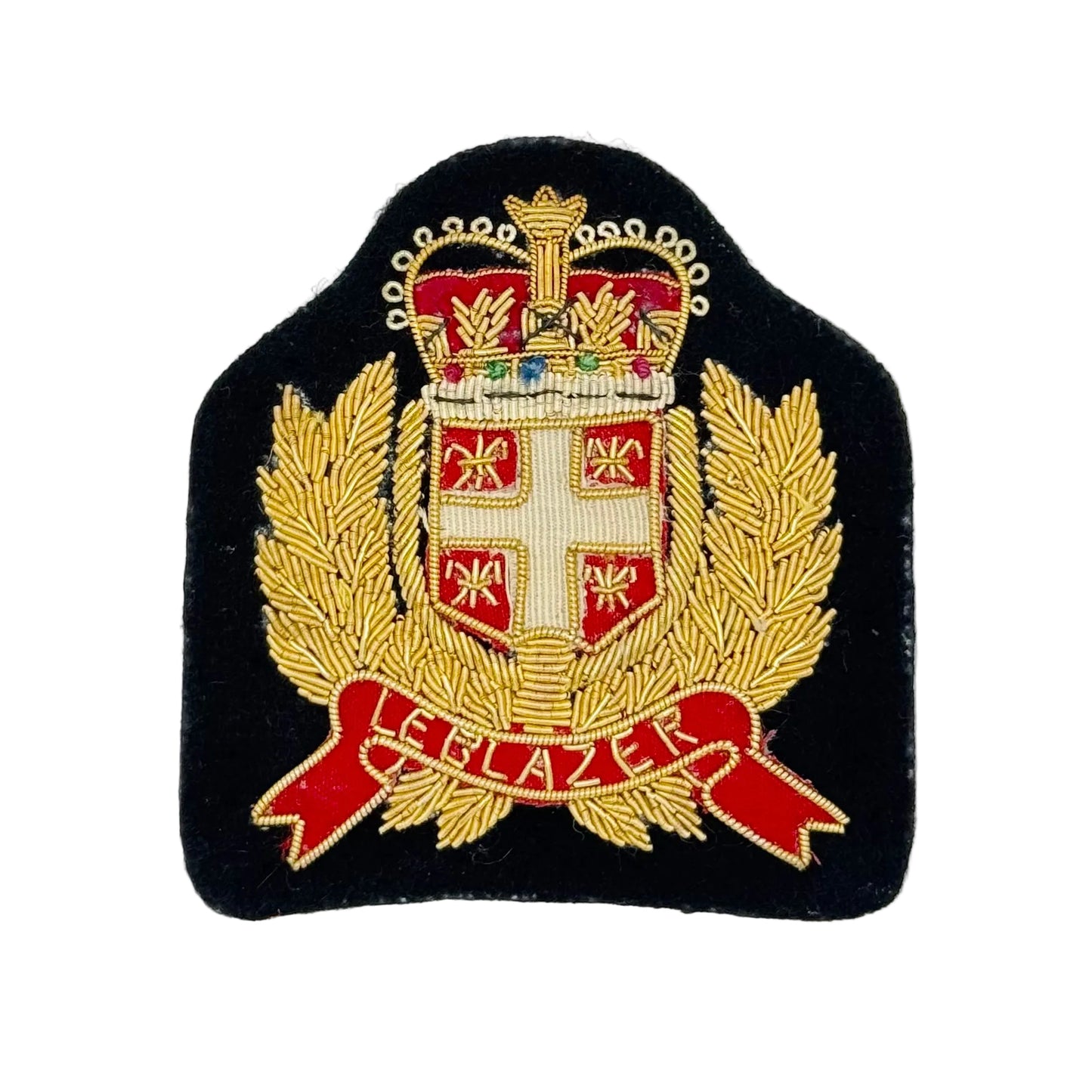 An embroidered military-style crest patch on a black fabric background, featuring a gold crown, laurel branches, a white cross on a red shield, and a red scroll with gold lettering, photographed against a plain white background.