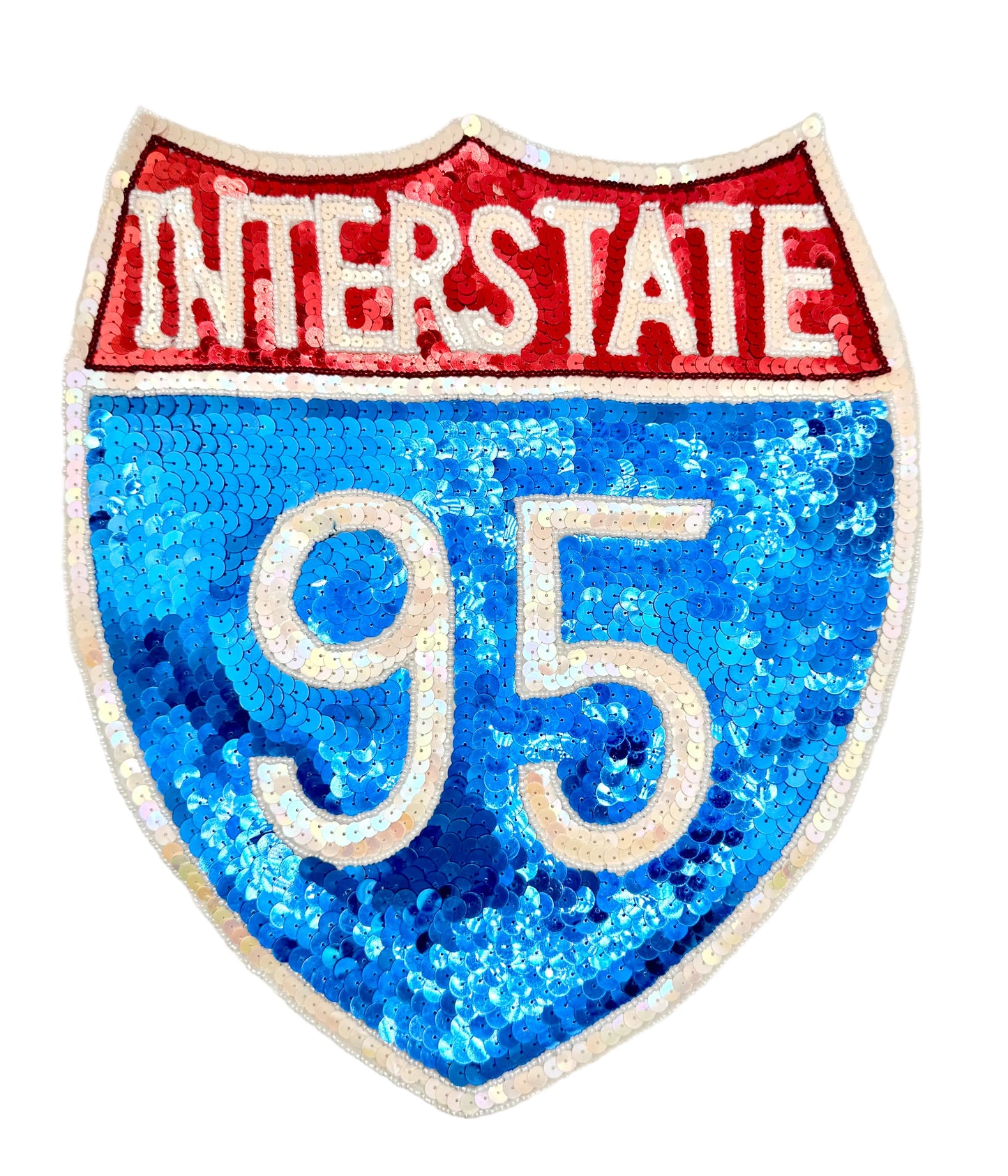 A shield-shaped sequin patch designed like the Interstate 95 highway sign, featuring a red top section with white 'INTERSTATE' text and a blue lower section with white '95' text, on a plain white background.