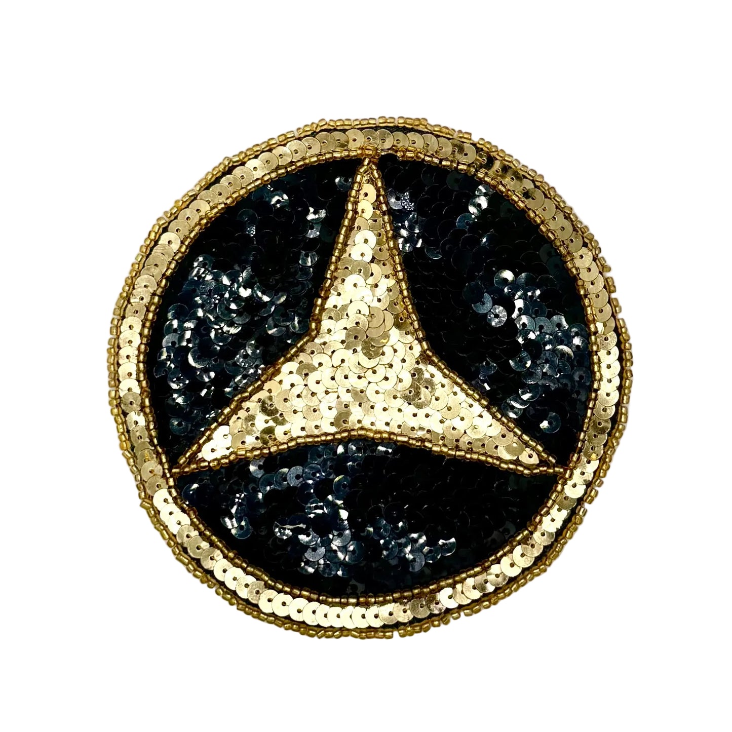 A vintage circular Mercedes-Benz star patch embellished with gold sequins and black sequins, set against a light gray textured background.