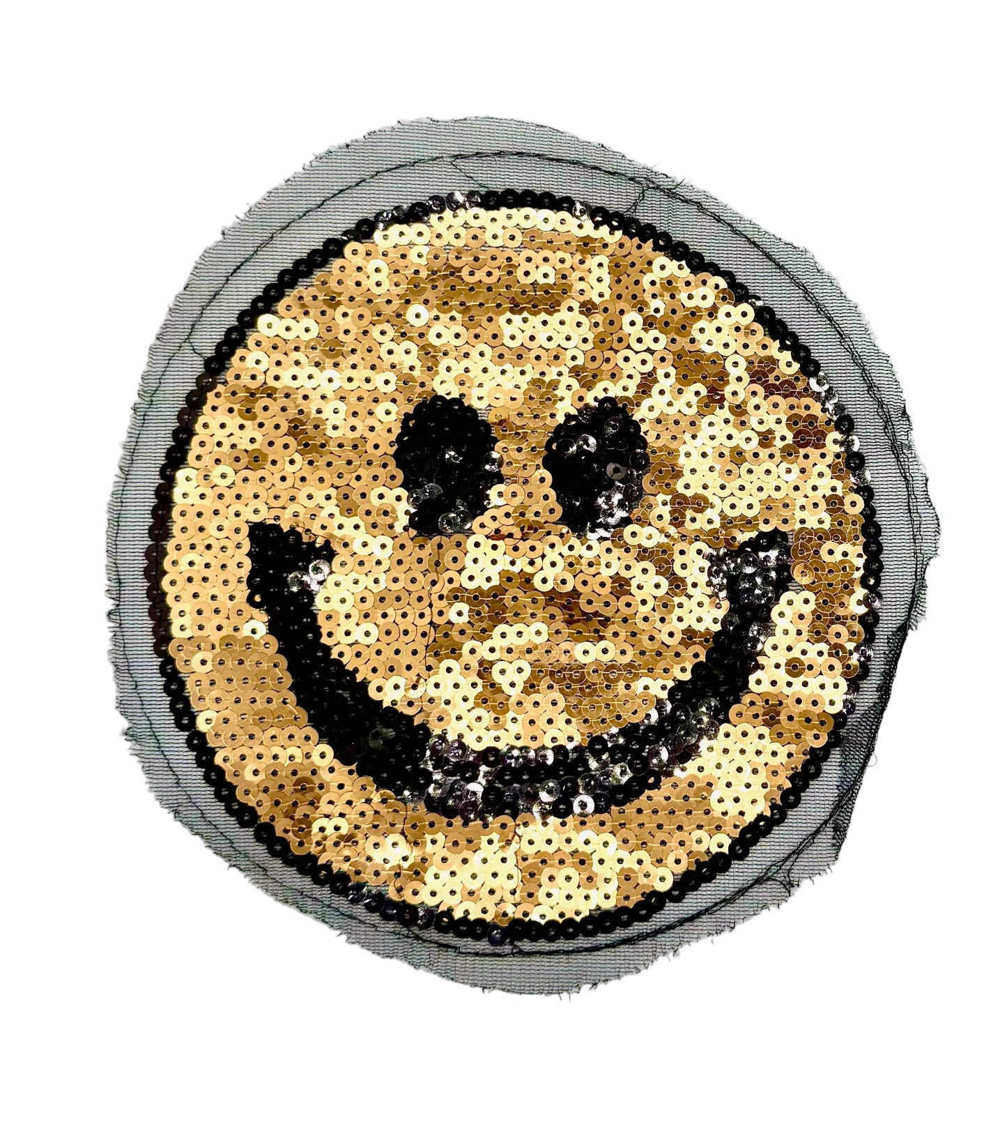 A circular sequin patch featuring a smiley face design. The face is made of shimmering bronze sequins with black sequins forming the edge, eyes and mouth, bordered by a gray mesh backing on a white background.