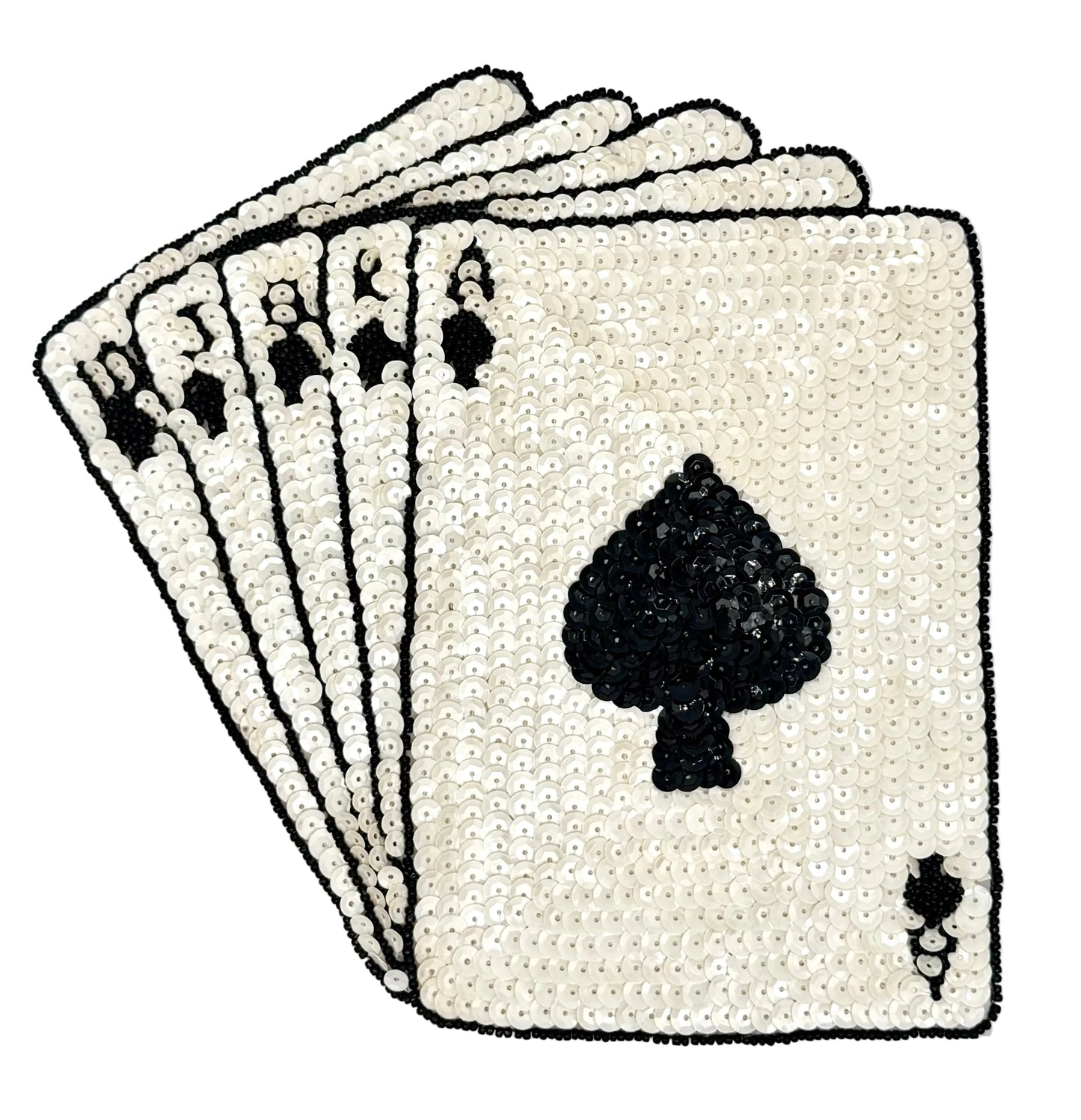 Ivory and black colored sequin playing cards with an ace of spades on a white background