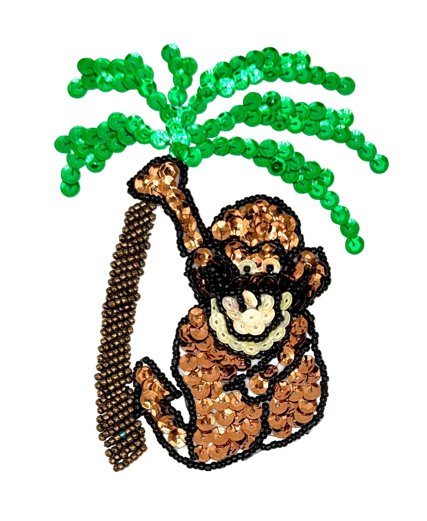 Sequined monkey holding a palm tree on a white background