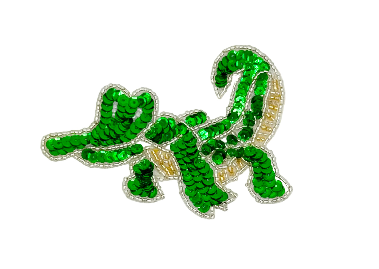 Green sequin alligator design on a white background