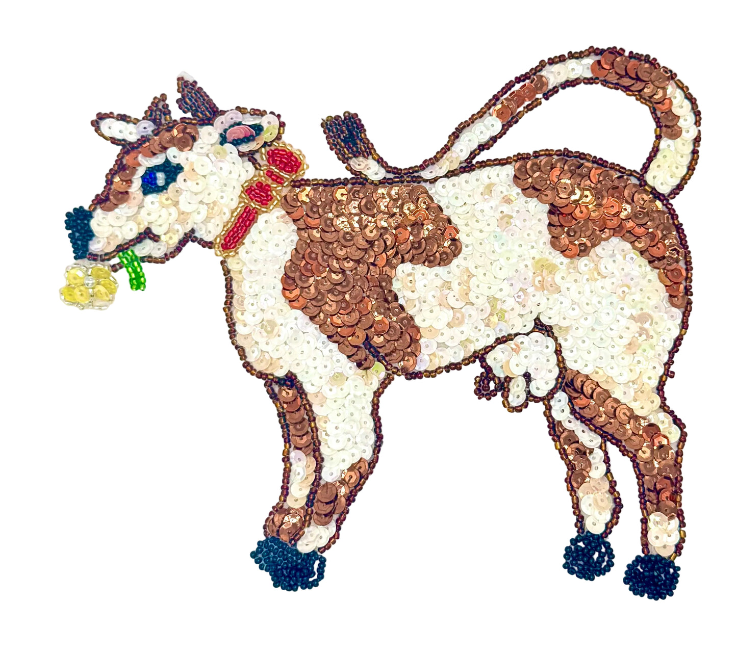 Decorative cow figure made of sequins on a white background