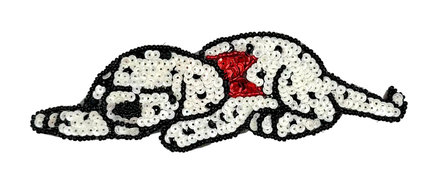 Sequined Dalmatian dog patch with a red bow on a white background