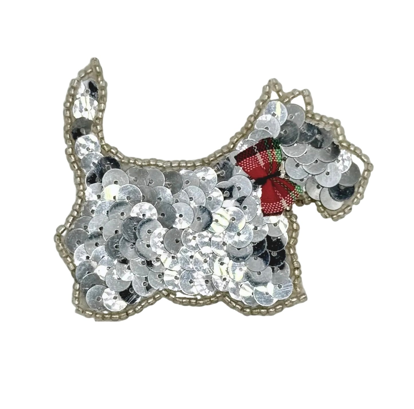 Sequined scottie dog patch with a red bow on a white background