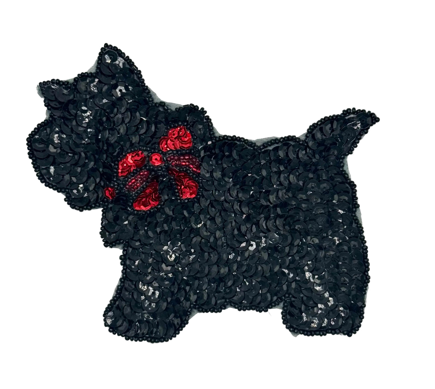 Black sequined dog with a red bow on a white background