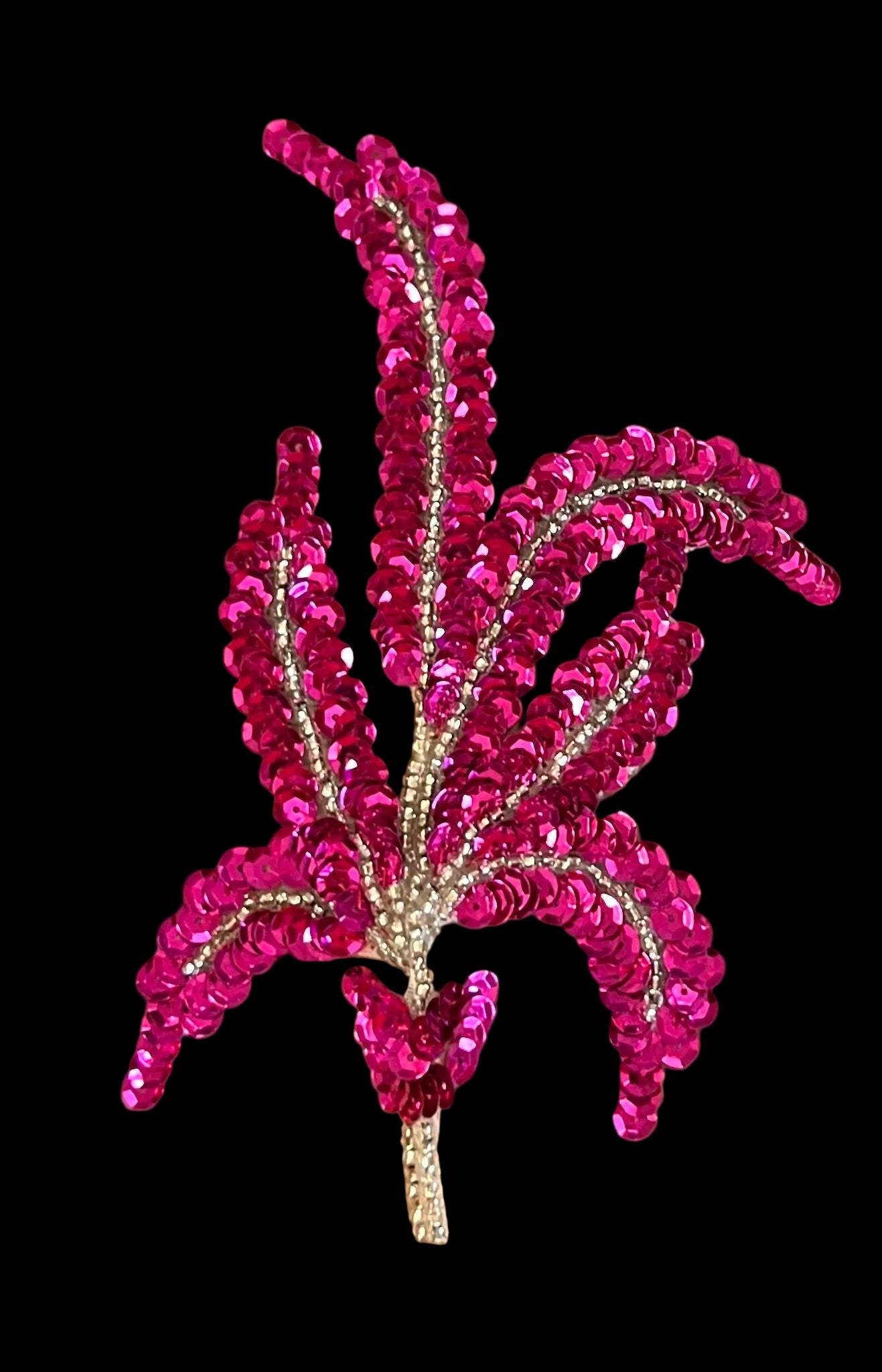 Fuchsia sequin floral design on a brown background