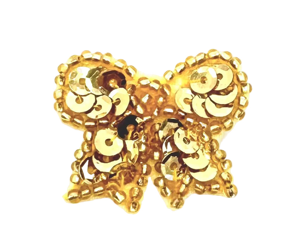 Gold bow with sequins and beads on a white background
