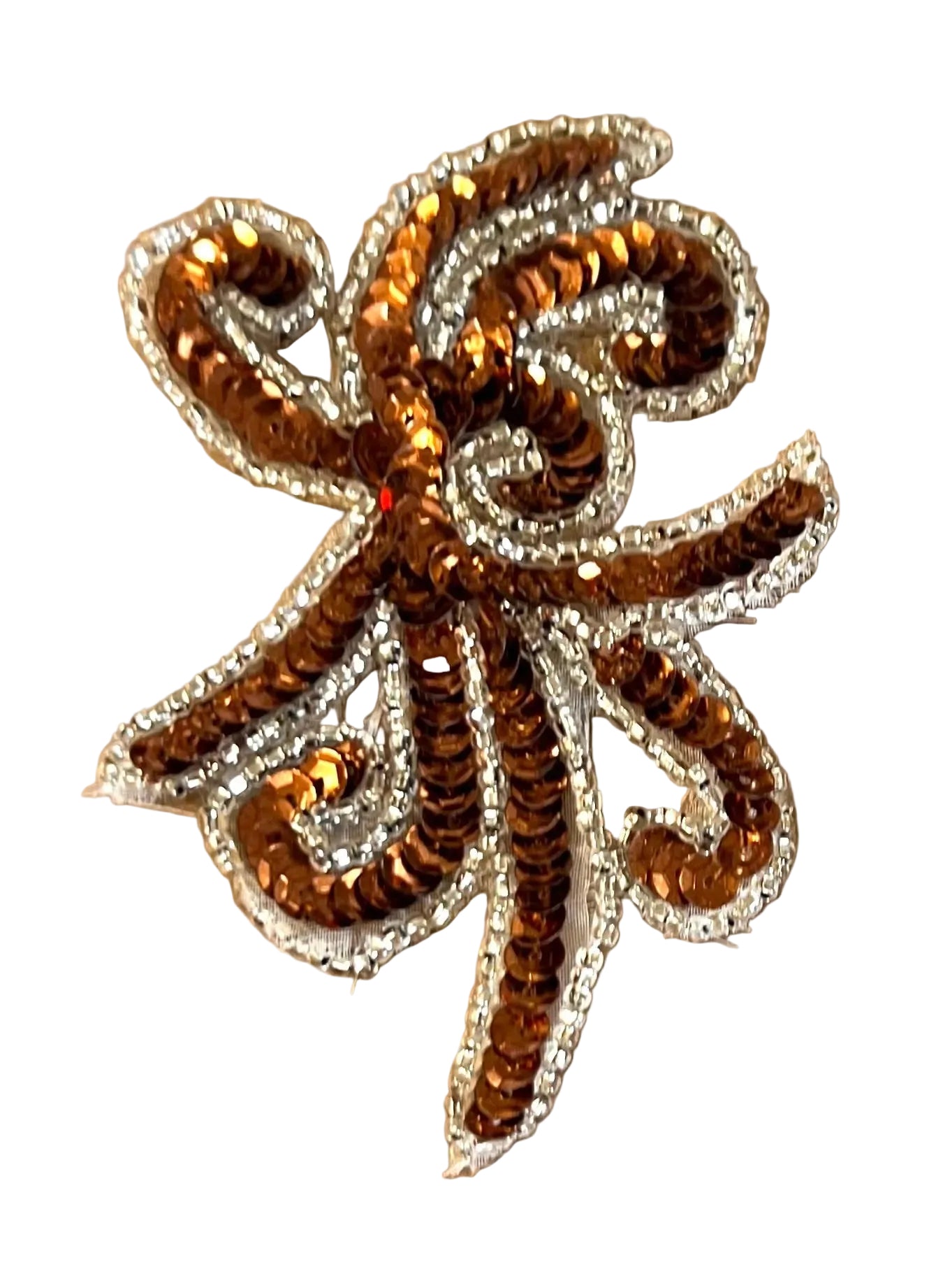 Decorative appliqué with brown and gold elements on a white background