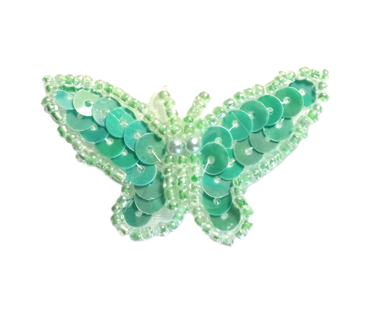 Green butterfly with sequins and beads on a white background