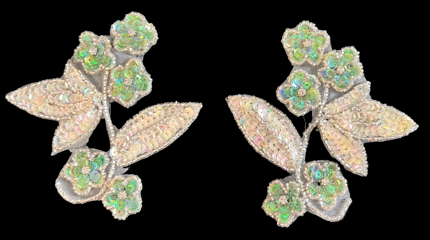 Sequin floral pair with green and silver leaves on a black background