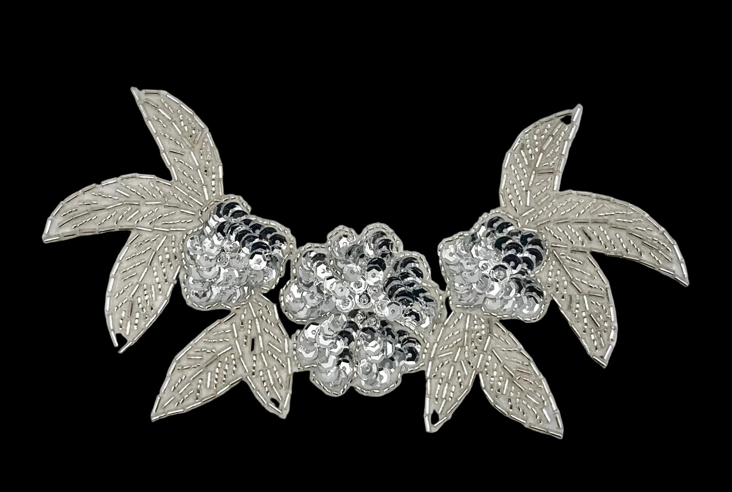Sequin and beaded silver leaf and flower design on a white background