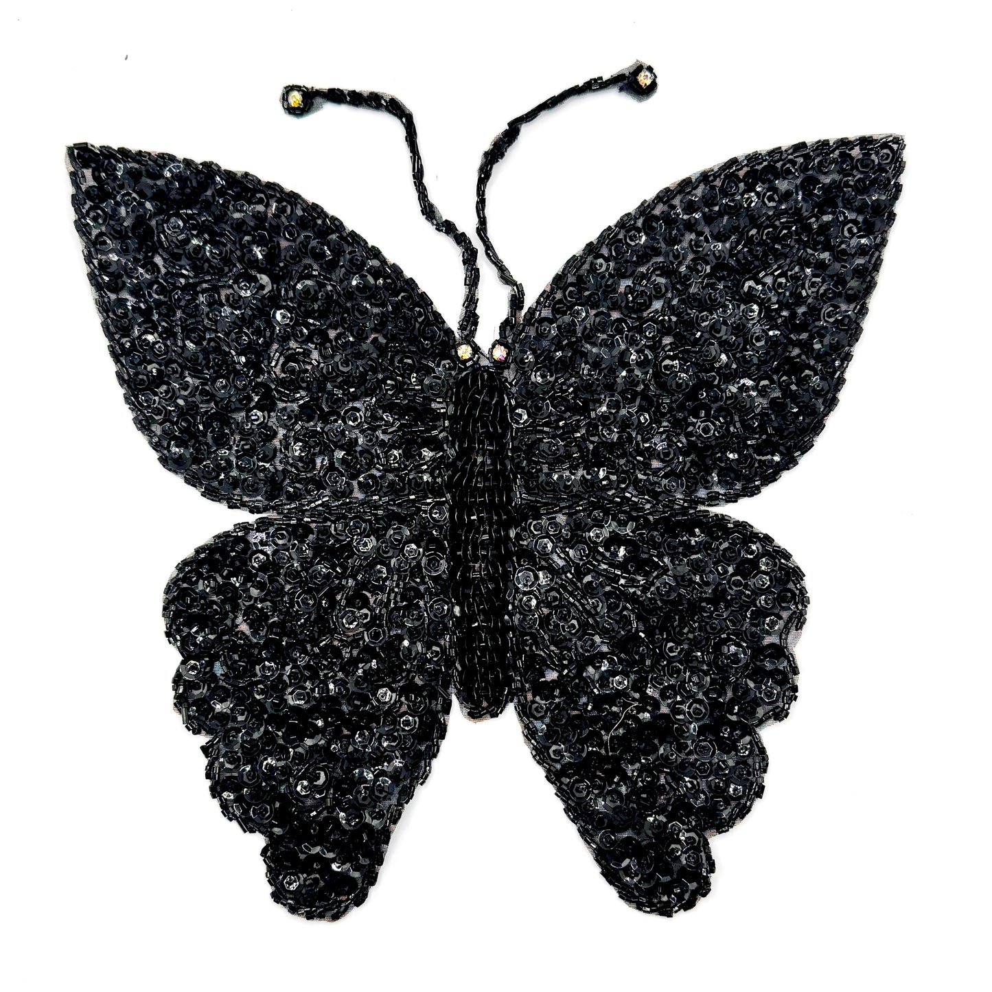A handmade black butterfly applique with sequins and beads