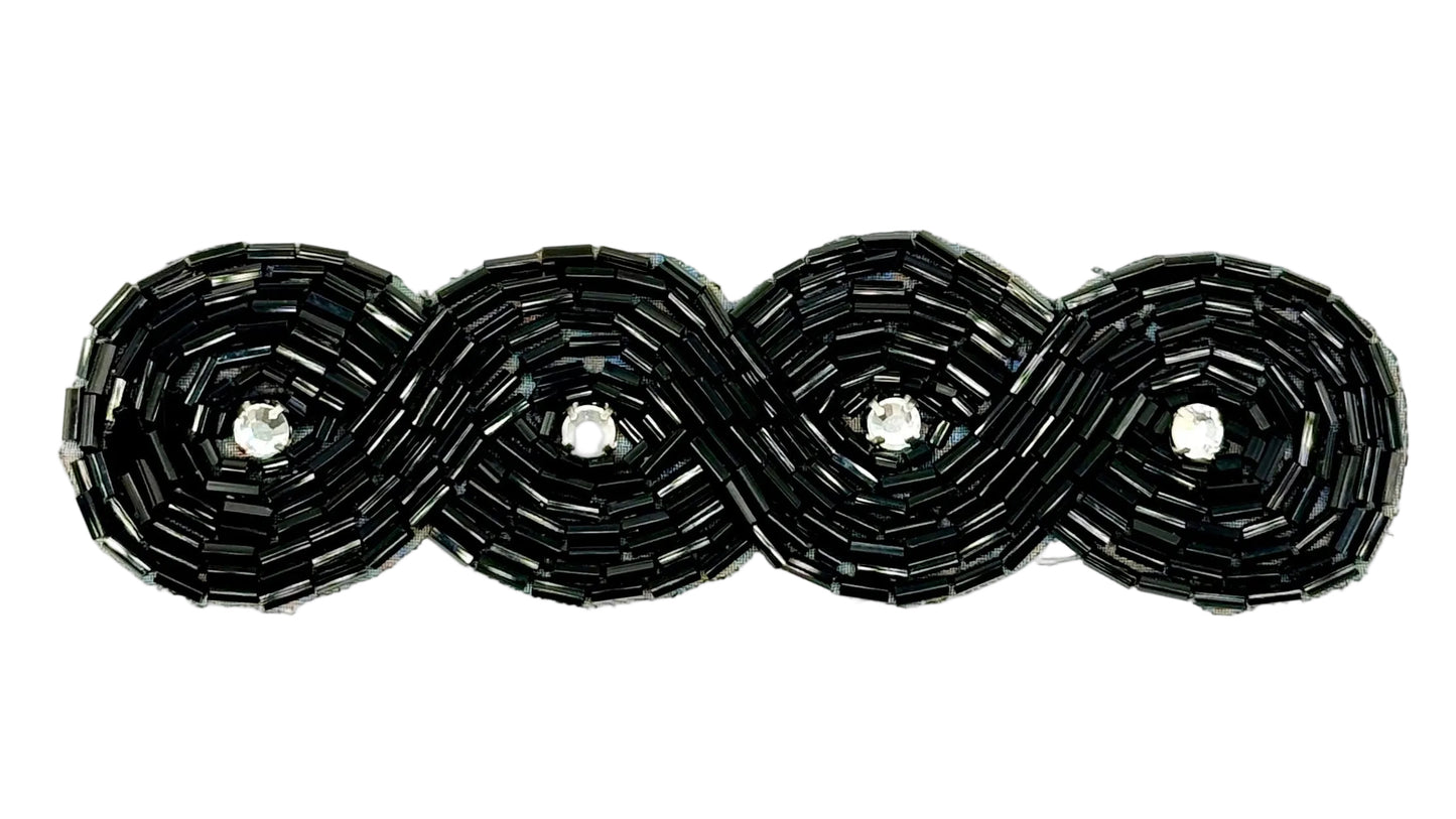 Black beaded accessory with rhinestone centers on a white background