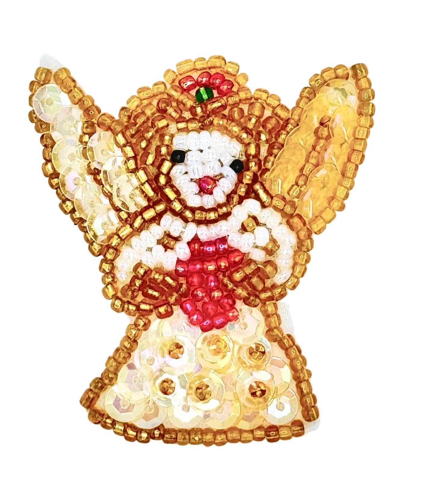 A beaded Christmas angel ornament featuring a white beaded face and hands, a red beaded scarf and bow, and gold and cream sequins forming wings and a dress, set against a plain white background.