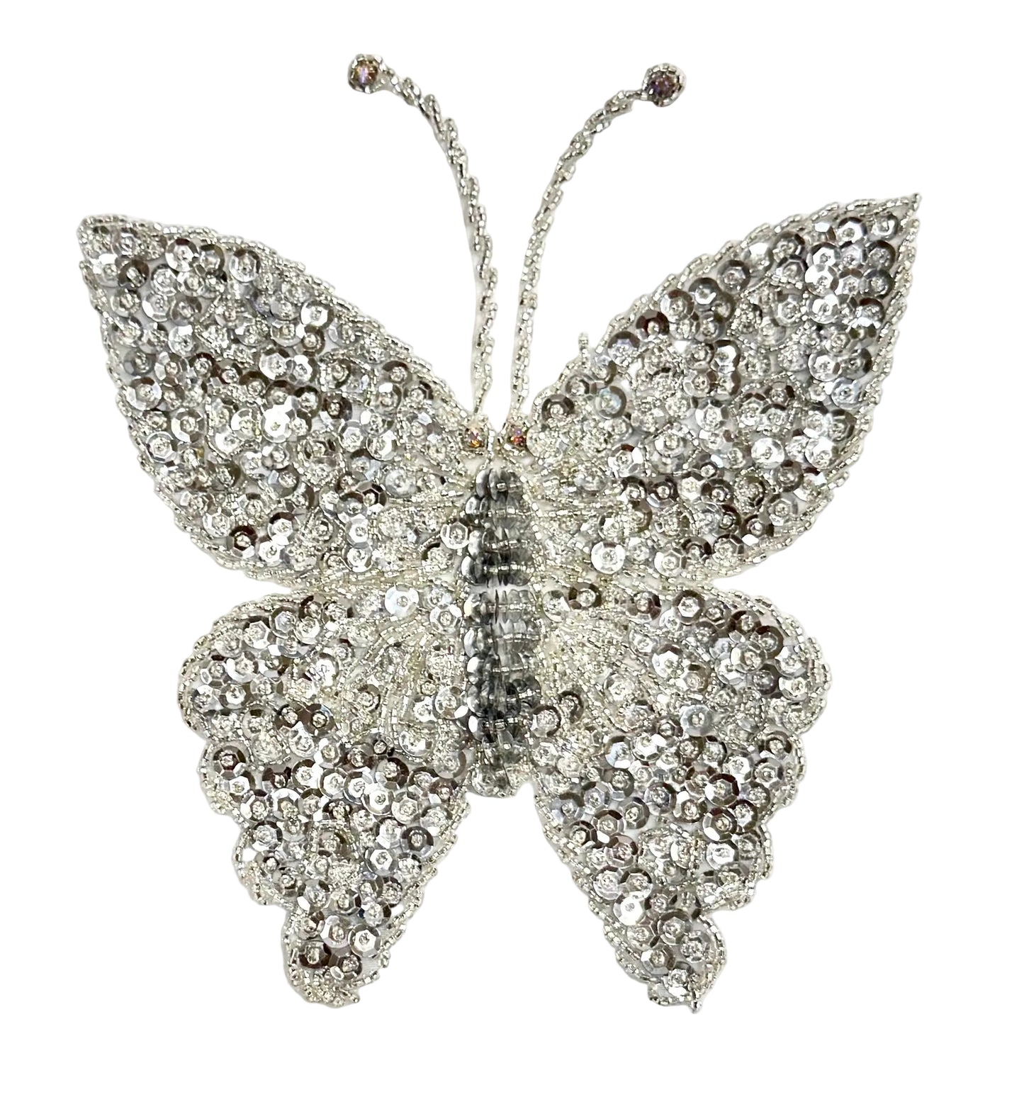 Silver sequin and bead butterfly decorative item on a white background