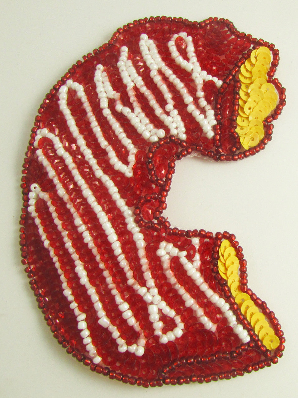 Dona a medio comer con glaseado rojo y blanco 4.5" x 3"