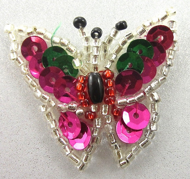 Butterfly-shaped patch with sequins on a light gray background