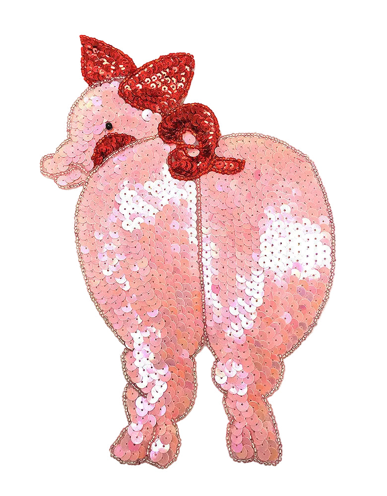 Sequined pig patch with a red bow on a white background