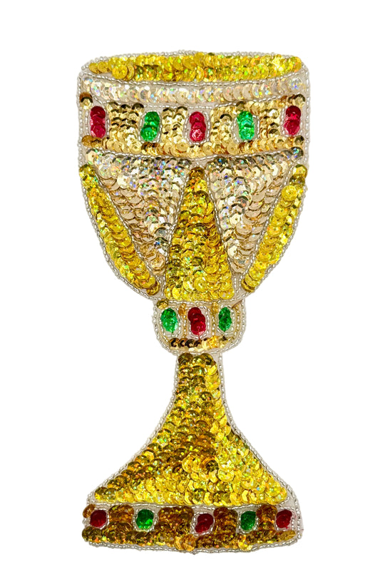 Decorative gold goblet with sequin and glass bead on a white background