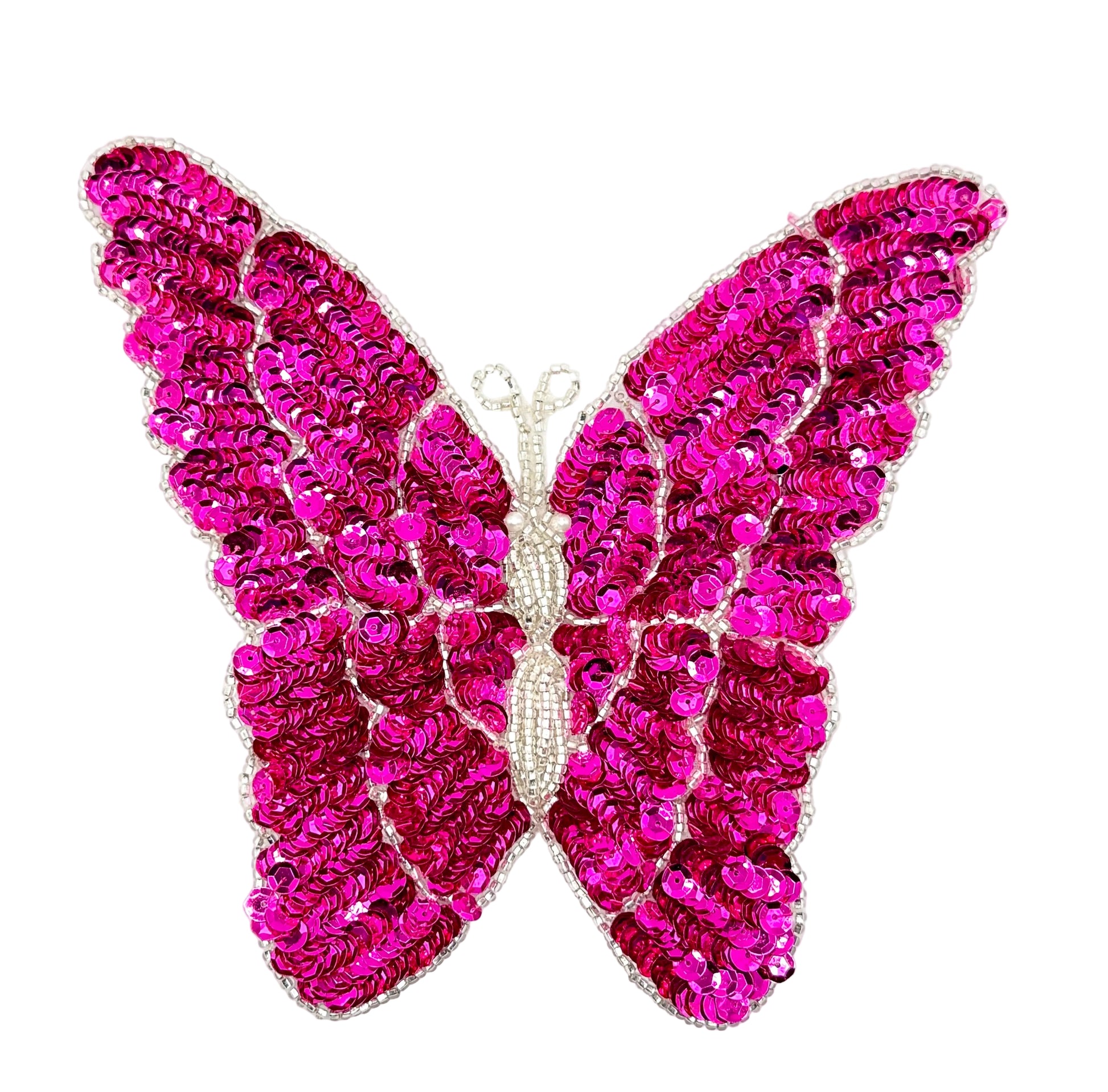 Fuchsia butterfly-shaped patch with sequins on a white background