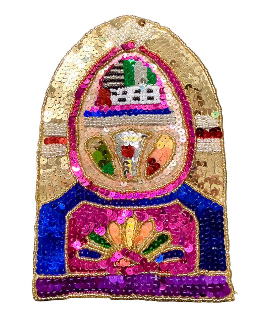 A highly decorative, hand-sequined patch featuring a juke box. The patch is embellished with gold sequins, bright blue, magenta pink, purple, green, and orange sequins, and small bead details, set against a plain white background.