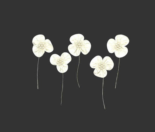 Five white satin flower embellishments with silver wire stems, arranged on a plain white background.tin 