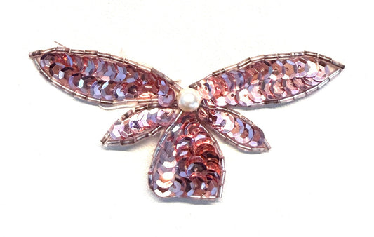 Pink butterfly-shaped patch with a pearl center on a white background