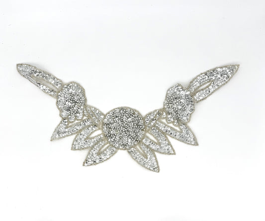 Decorative silver sequin and bead neckpiece on a white background