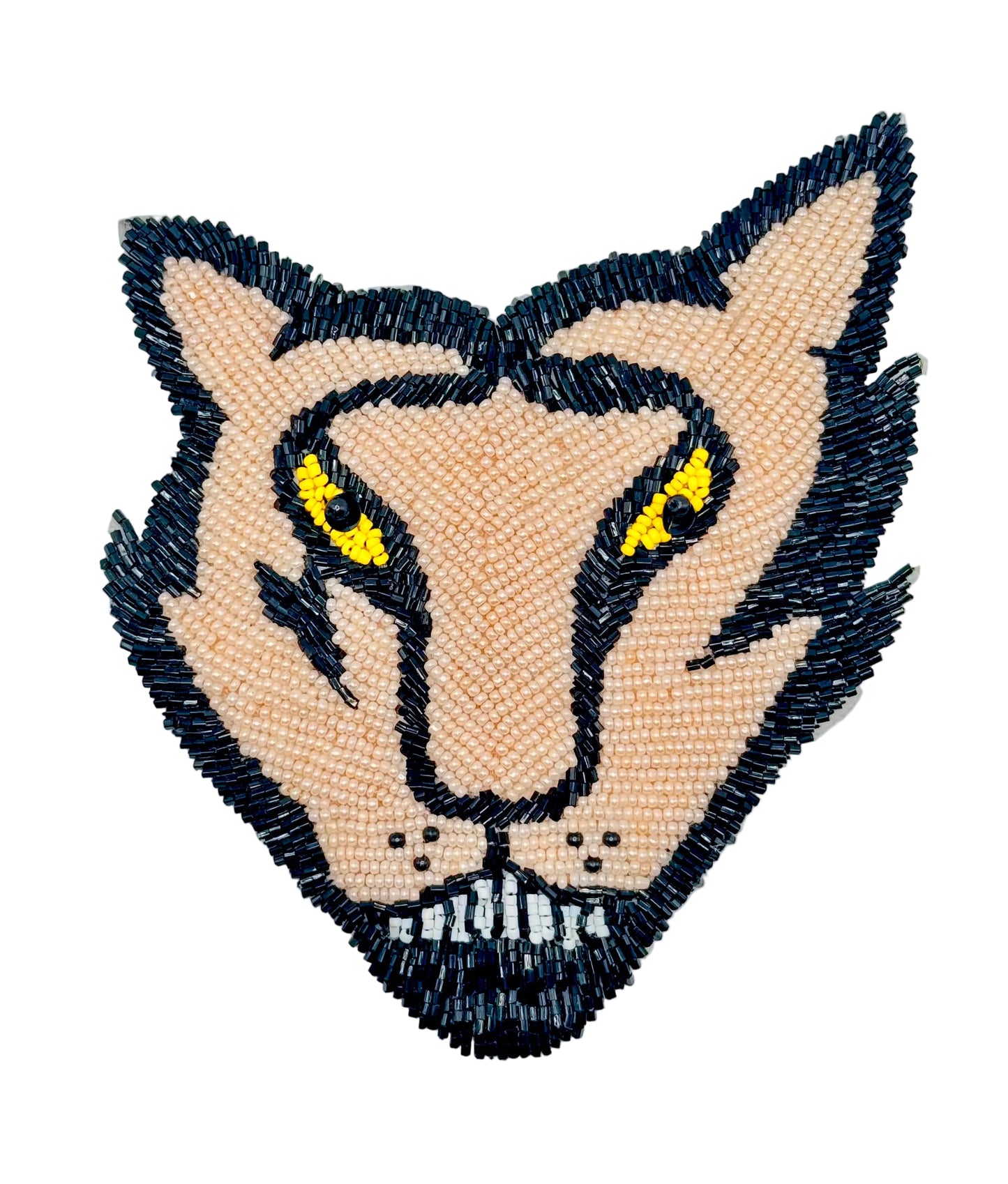 Beaded patch of a cougar's  head with black, light peach, white and yellow details on a white background