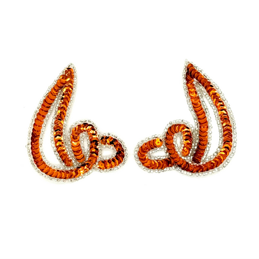Pair of orange and silver sequin appliqués on a white background