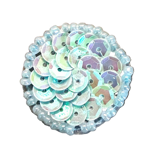 Round sequin embellishment with iridescent finish on a white background