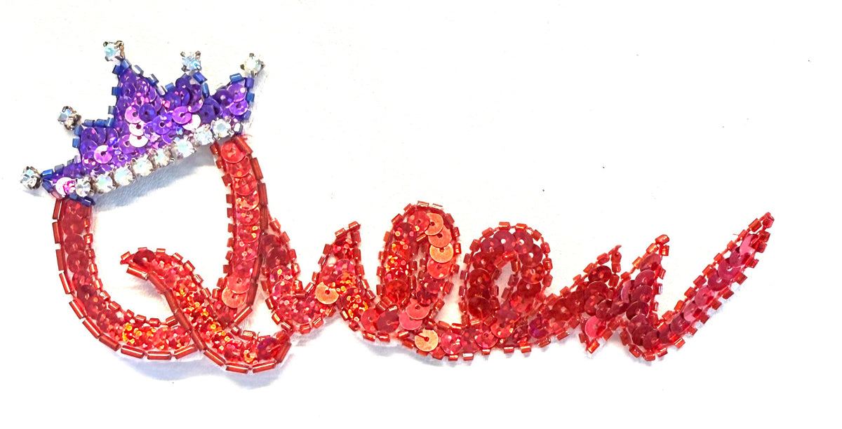 The word Queen in red sequins and beads, purple sequins and beads and AB rhinestones on a white background. 