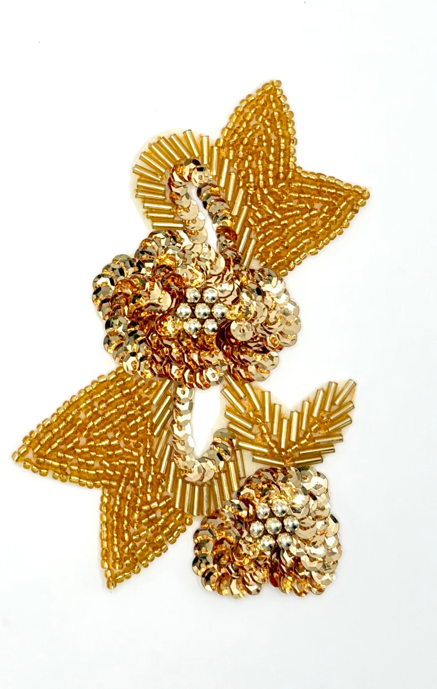 A gold sequined and bead patch featuring stylized floral and leaf motifs, photographed on a clean white background.