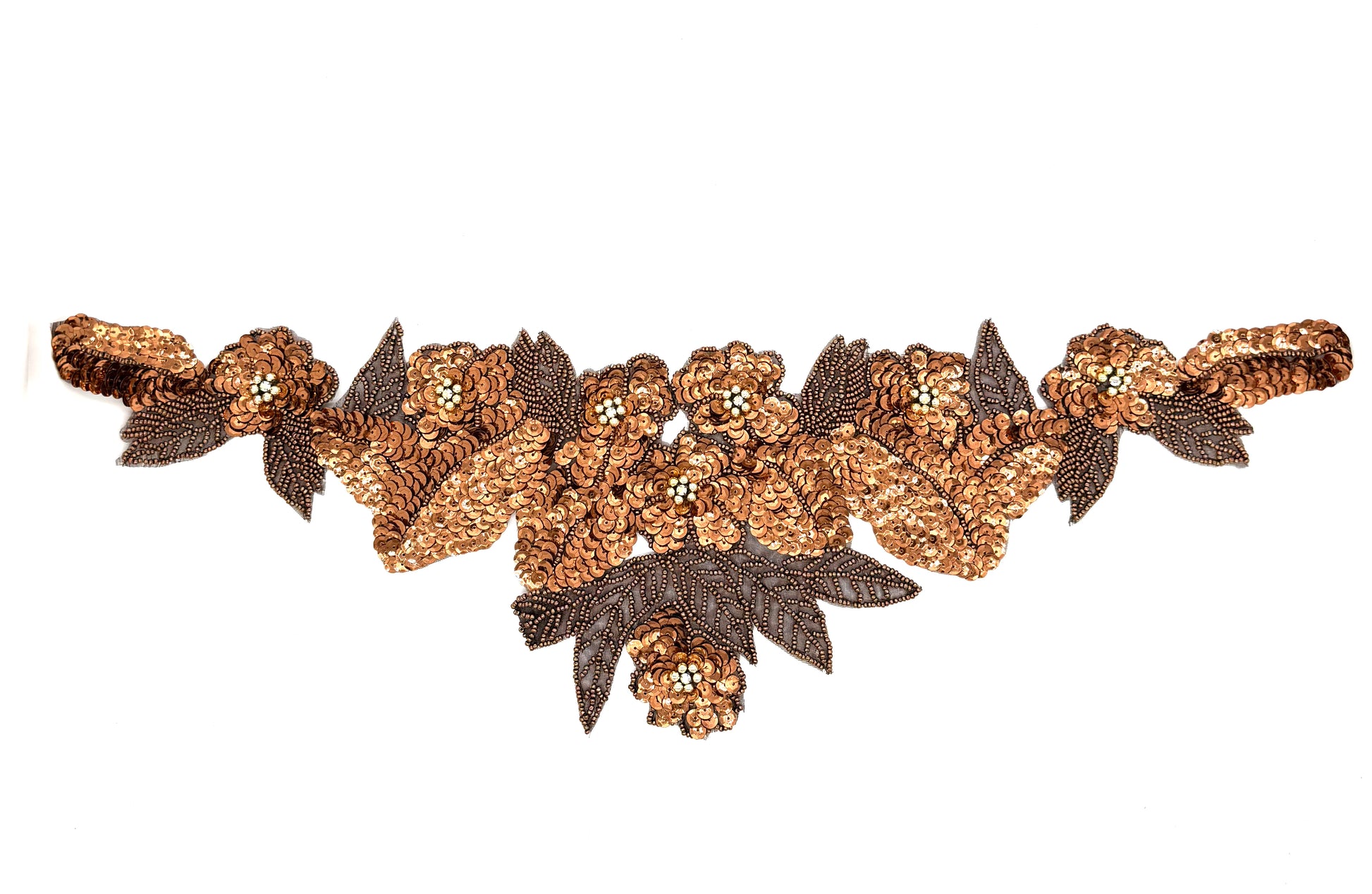 Decorative floral pattern in gold and bronze sequins and beads on a white background