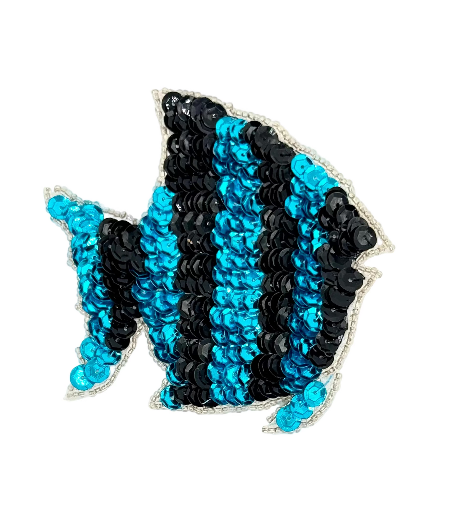 Sequined fish-shaped decorative item with blue and black pattern on a white background