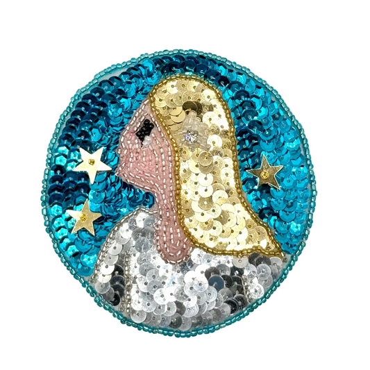 Zodiac Virgo sequin and bead badge with a face design on a white background